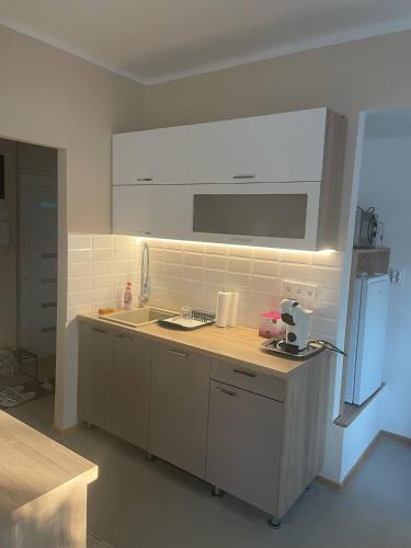 a kitchen with a sink and a counter top at Club4C Apartman in Makó