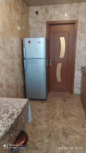 a kitchen with a refrigerator next to a door at квартира in K'obulet'i
