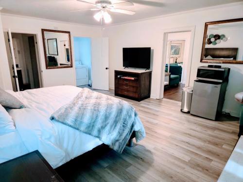 a bedroom with a bed and a flat screen tv at Cozy 4 bedroom home & Large Fenced Yard in Fayetteville