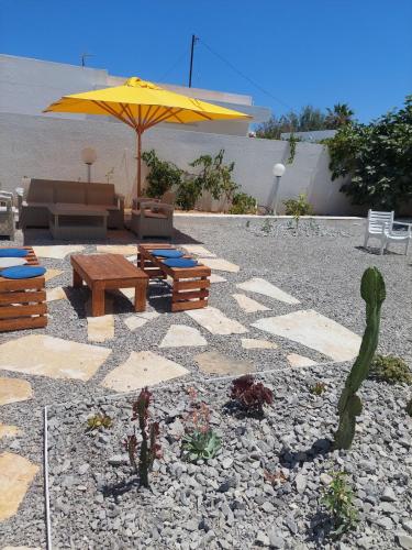 a patio with an umbrella and a couch and table at Dar Aïcha 