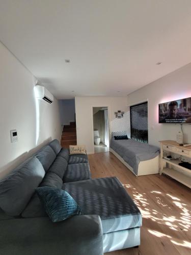 a living room with a couch and a table at Moliceiro HOUSE in Aveiro