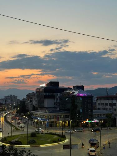 a city with a lot of traffic and buildings at Apartment CityHeart in Ohrid