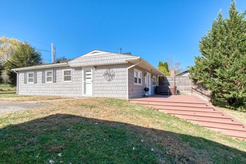 a small white house with a large driveway at New River 3BR - Fishing, Hot Tub and VT Game Weekends in Radford