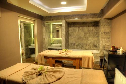 a room with a table and a bath tub at Le Bleu Hotel & Resort Kusadasi in Kusadası