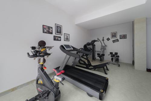 a gym with two tread machines and a treadmill at Warm Shore in Taiping