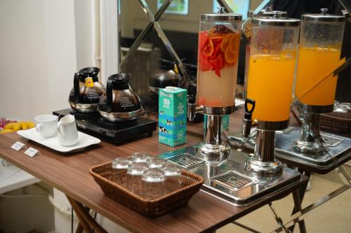 a table with two glasses of orange drinks on it at Hanoi Oldtown Nomad Hostel in Hanoi
