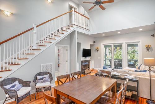 a living room with a table and chairs and a staircase at Tasteful 2 Story 4 Bedroom, 4 Bath Home! New on Rental Program, Sleeps 12! in Fripp Island