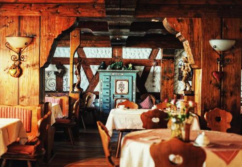 a restaurant with two tables and chairs and wooden walls at Hotel Gondel in Altenkunstadt