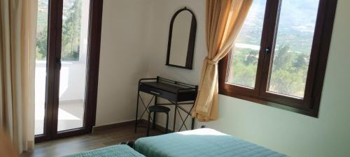 a bedroom with a bed and a sink and a mirror at Agrikia House fully renovated peaceful 1km from Plakias beach in Plakias