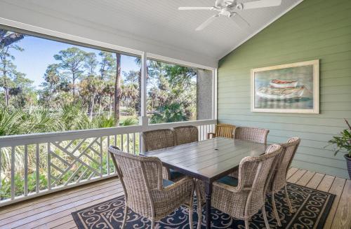 a dining room with a table and chairs on a balcony at Tasteful 2 Story 4 Bedroom, 4 Bath Home! New on Rental Program, Sleeps 12! in Fripp Island