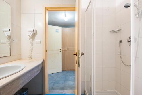 a bathroom with a sink and a shower at Hotel La Caletta Village in La Caletta