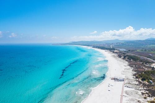 an aerial view of the beach and ocean at Hotel La Caletta Village in La Caletta