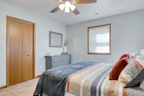 a bedroom with a bed and a ceiling fan at New River 3BR - Fishing, Hot Tub and VT Game Weekends in Radford
