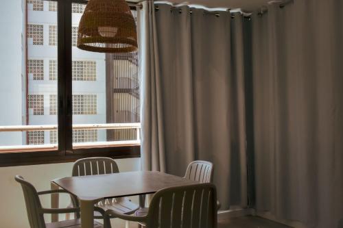 a table and chairs in a room with a window at Now Benidorm in Benidorm