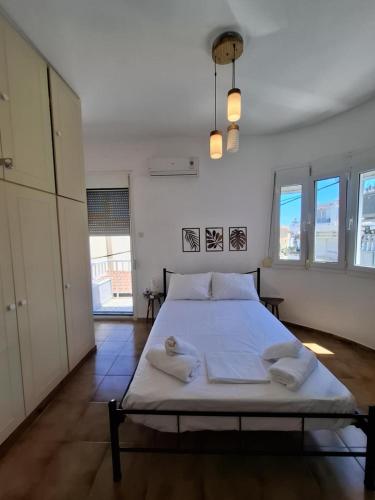 a bedroom with a bed with two pillows on it at Not quite a treehouse in Vrontados