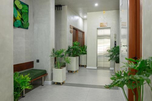 a hallway with potted plants in a building at TA Hotel - Hue City Center in Hue