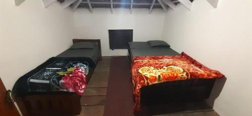 a room with two beds in a room at Coffee grove homestay in Chikmagalūr