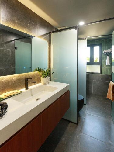 a bathroom with a sink and a shower at TA Hotel - Hue City Center in Hue