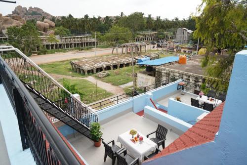 a view from the balcony of a resort with a table and chairs at Ranjana Guesthouse in Hampi