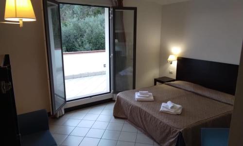 Postel nebo postele na pokoji v ubytování Hotel I' Fiorino
