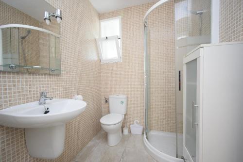 a bathroom with a sink and a toilet and a shower at ALLONAYA - Fincas Arena in Benidorm