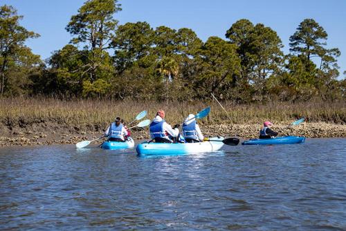 a group of people in kayaks on the water at 501 Sunsuite in Fripp Island