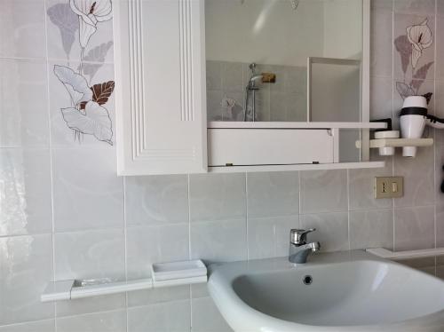 a bathroom with a sink and a white cabinet at IseoLakeRental - Casa Chicca in Esmate