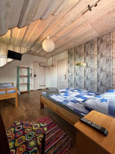 a bedroom with a large bed and a wooden ceiling at Na zielonej łące... in Ruciane-Nida