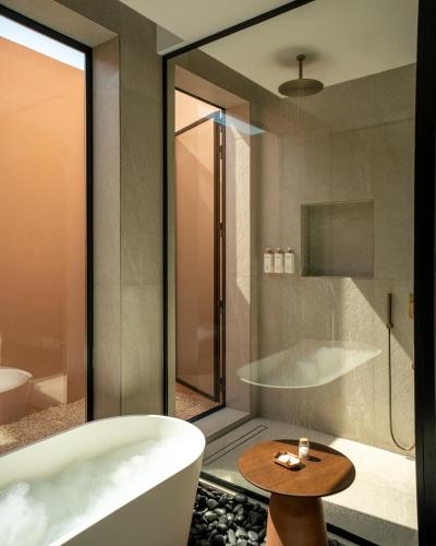 a bathroom with a bath tub and a sink at Meliá Desert Palm Member of Meliá Collection in Dubai