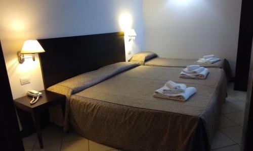 Postel nebo postele na pokoji v ubytování Hotel I' Fiorino