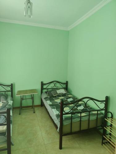 a bedroom with two bunk beds and a table at Ureki Mare House in Ureki