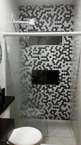 a bathroom with a glass shower with a toilet at Apt FIG 2025 in Garanhuns