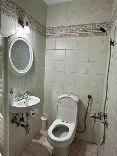 a bathroom with a toilet and a sink at Stagiates House in Stagiates