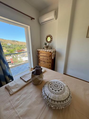 Un dormitorio con una cama grande con una ventana grande. en Avra House, en Caristo
