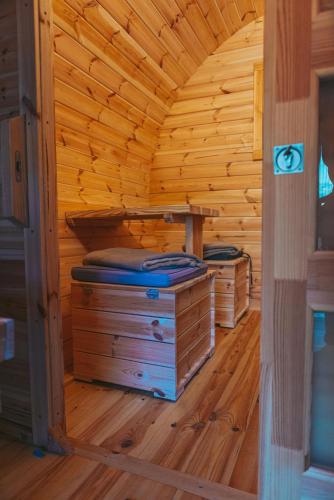 a wooden cabin with two beds in a room at Happis Fassle in Tarrenz