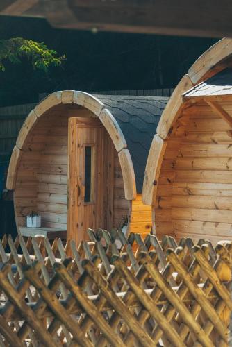 a wooden cabin with a door and a fence at Happis Fassle in Tarrenz