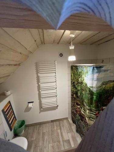 a bathroom with a painting on the wall at Na zielonej łące... in Ruciane-Nida