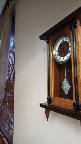 a wooden clock hanging on a wall at Panorama Self Catering 2 in Panorama