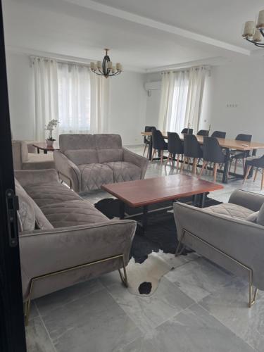 a living room with couches and a table and chairs at Bel horizon in Collo