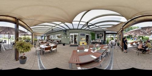 a building with tables and chairs and people in it at Penzion Set in Košice