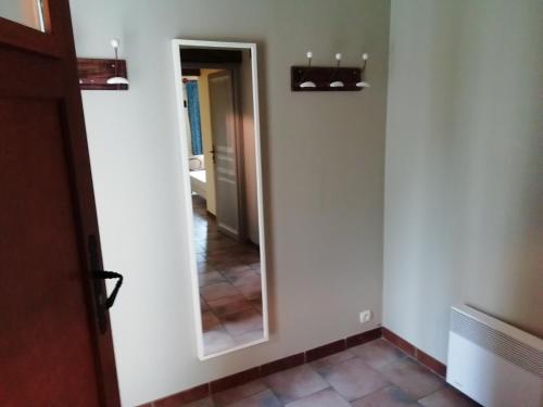 a mirror in a room with a hallway at Charming Chalet with Swimming Pool in Quend in Quend
