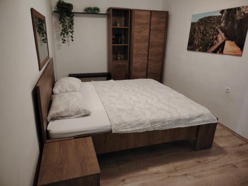 a bedroom with a bed with a wooden headboard at Prominska Bajka in Razvođe