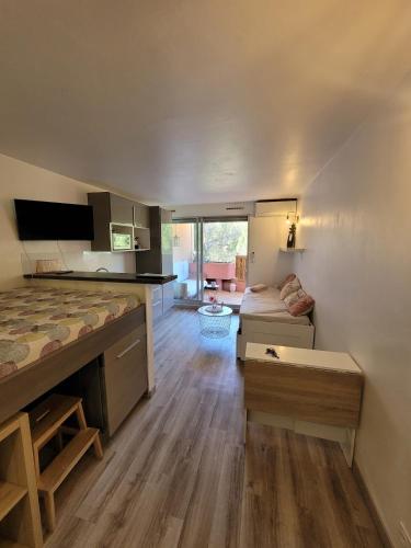 a room with a bed and a living room at Studio Bord de Mer Résidence - Les Sablettes in La Seyne-sur-Mer