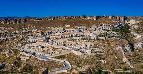 an aerial view of a village on the side of a mountain at Kayakapi Premium Caves Cappadocia in Urgup