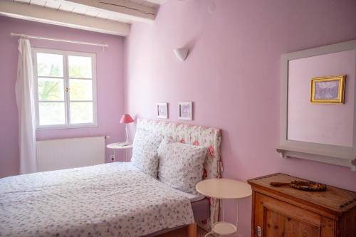 a bedroom with a bed and a table and a window at Family Hotel Okoř in Okoř