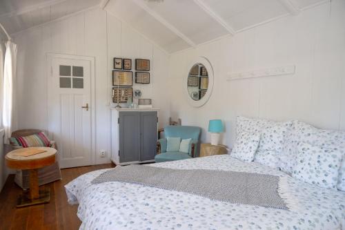 a bedroom with a bed and a blue chair at Family Hotel Okoř in Okoř