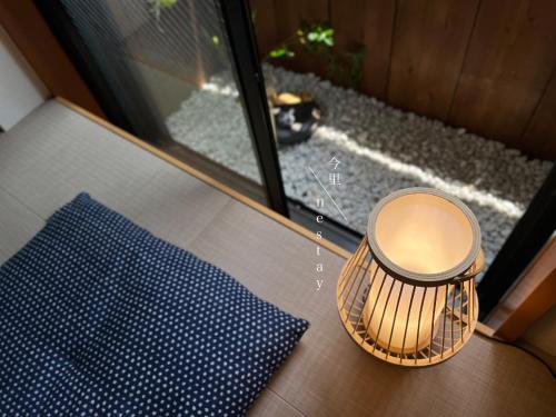 a trash can sitting on a table next to a window at nestay house osaka imazato in Osaka