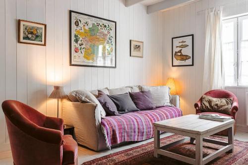 a living room with a couch and two chairs at Charming fisherman's cottage in Ars en Ré in Ars-en-Ré