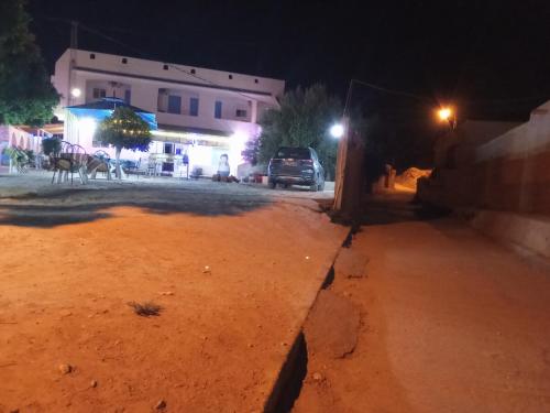 a street at night with a car parked on the street at dar fatma matmata in Matmata