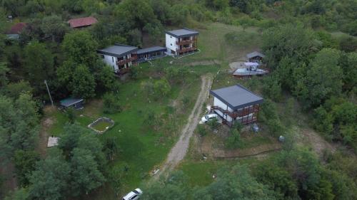 an aerial view of a house in the woods at ZEN Apartments in Măgura